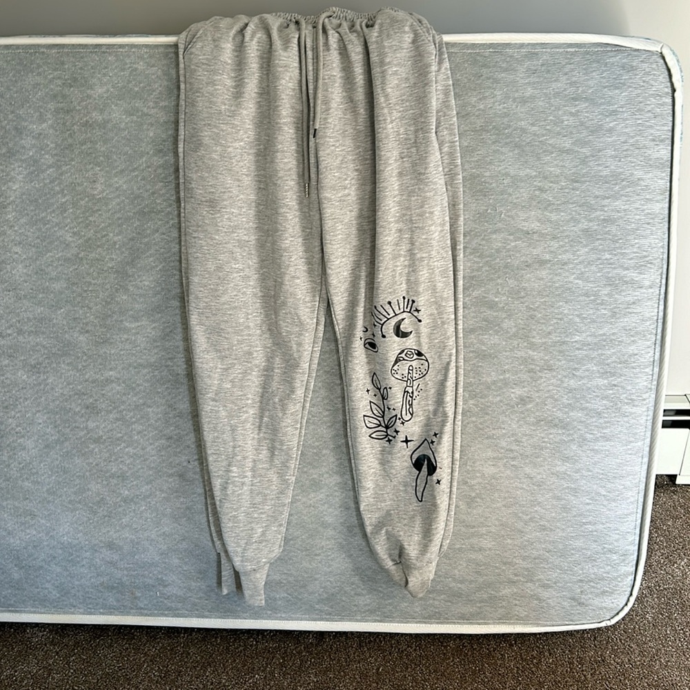 SHEIN pants with cute boho design on the bottom of the left leg